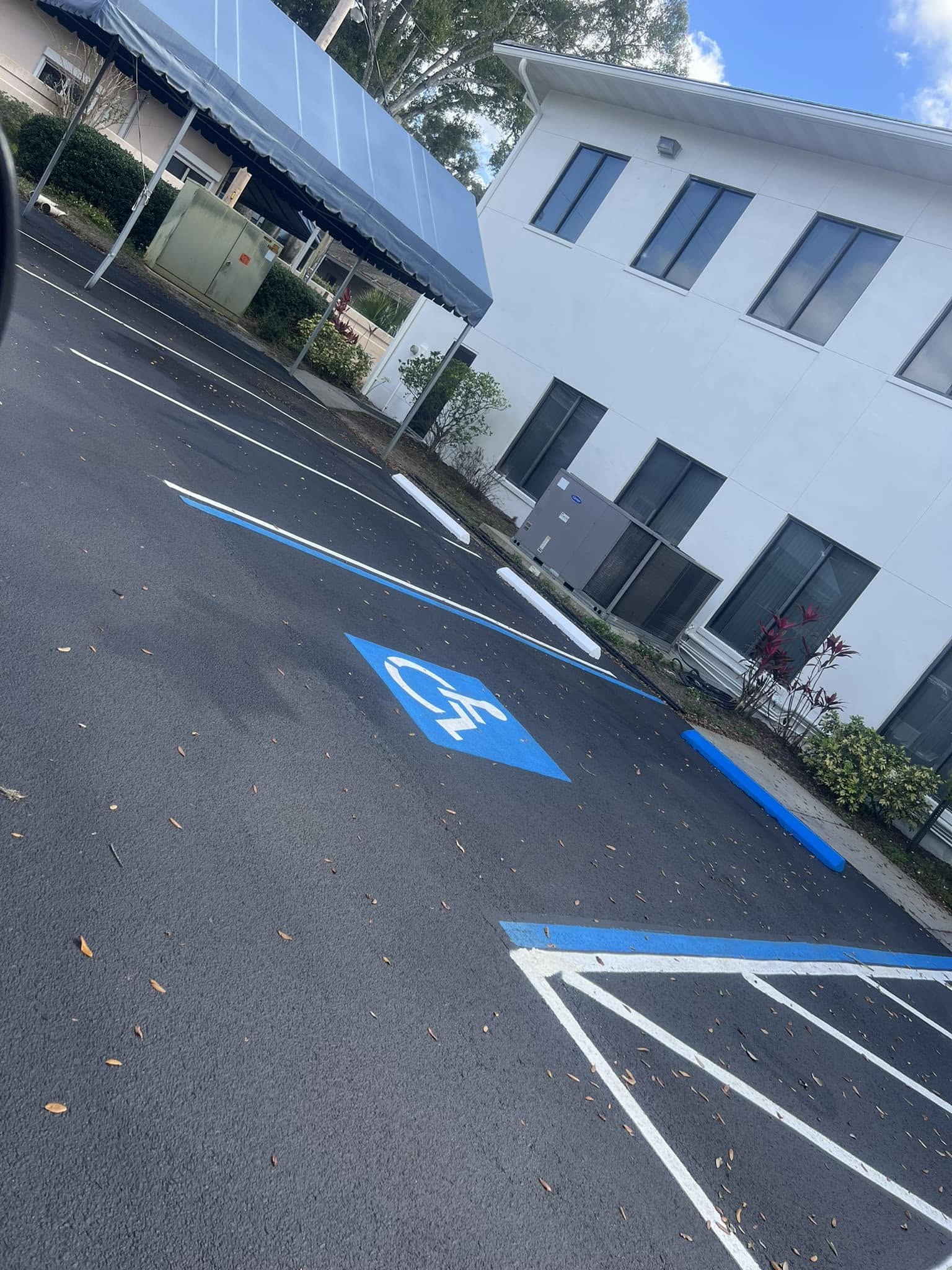 Parking area after resurfacing and accessible-space striping
