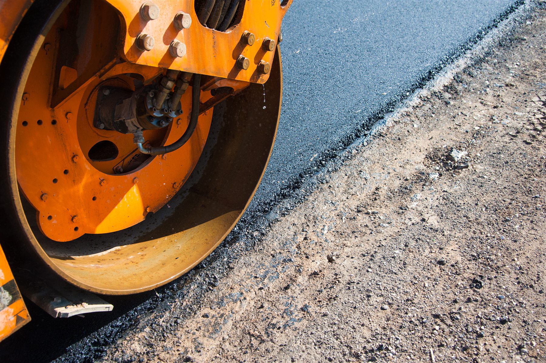 Close view of a road roller compacting asphalt